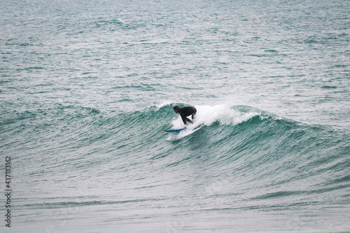 Surfer on Blue Ocean Wave . Surf spot in Ericeira Portugal.