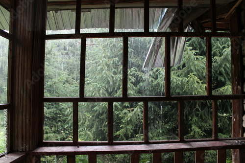 old window and downpour behind