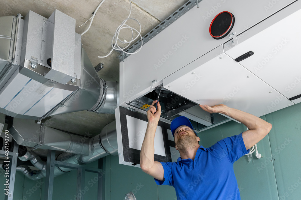 hvac technician install ducted heat recovery ventilation system with  recuperation Photos | Adobe Stock