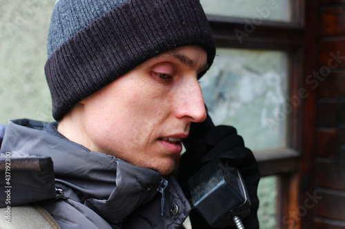 A young man is talking on Payphone photo