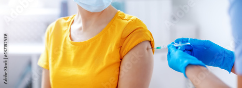 Nurse giving vaccine syringe against Covid 19 to patient.