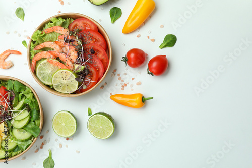 Concept of tasty eating with shrimp salads on white background