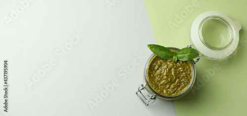 Konstfotografi Jar of Pesto sauce on two tone background
