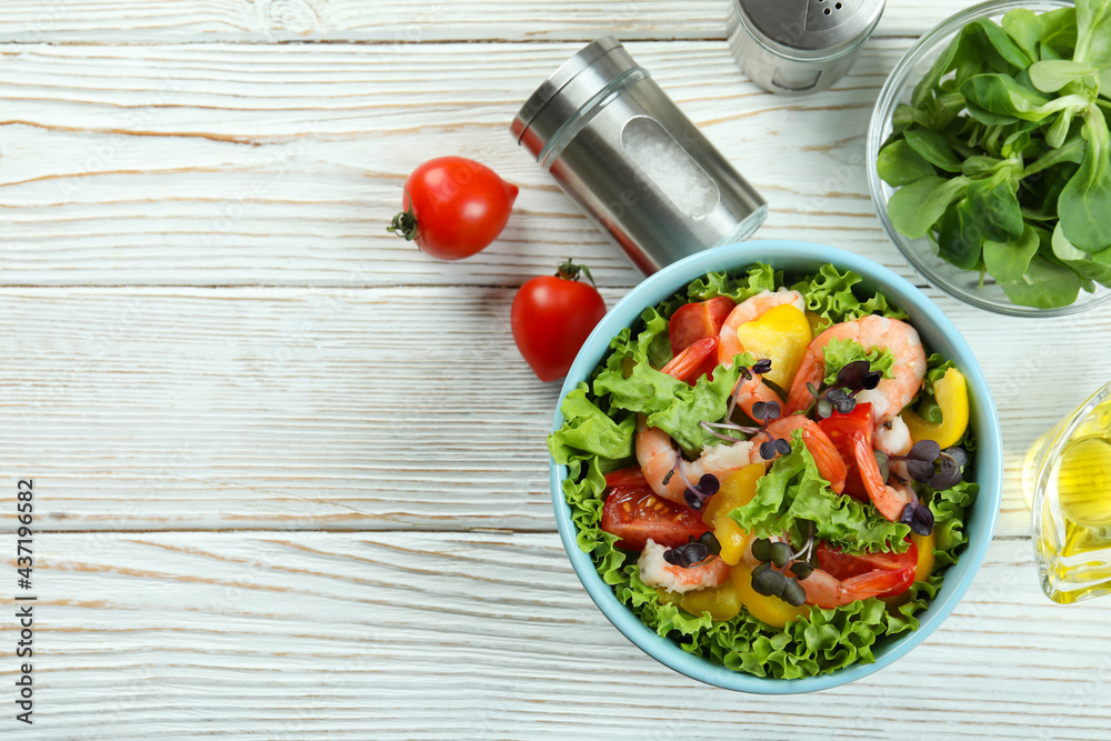 Concept of tasty eating with shrimp salad on white wooden table Concept of tasty eating with shrimp salad on white wooden table