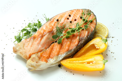 Tasty grilled salmon and ingredients on white background