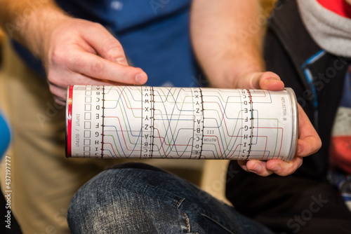 Paper imitation of a cylinder from an encryption, coding, secret enigma machine. Used for teaching or playing for children, students or logical training or cryptography studies at a university. photo