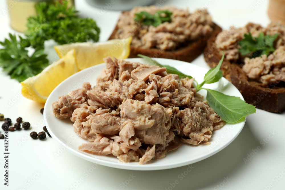 Concept of tasty eating with canned tuna on white background Concept of tasty eating with canned tuna on white background
