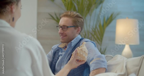 The footage was filmed in a purpose-built video studio scenery. Romantic story of a young family. Young and stylish man and woman on vacation by the sea.