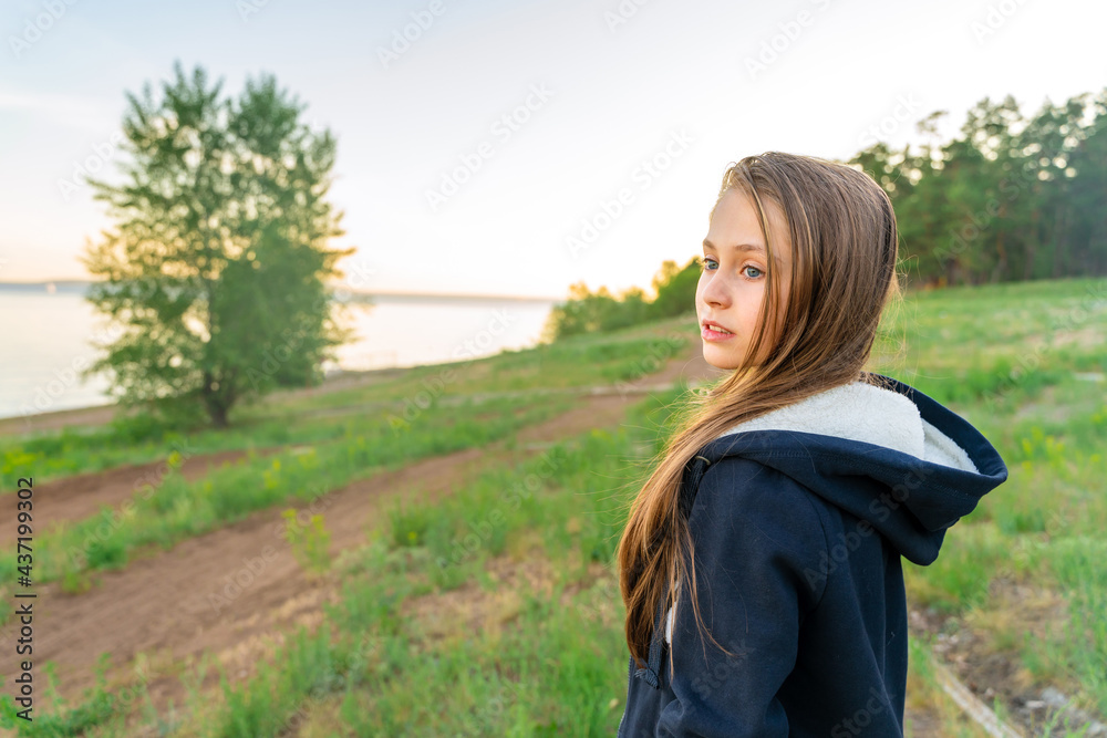 Little teen girl sad sitting in nature, the concept of teenage problems and mental health Little teen girl sad sitting in nature, the concept of teenage problems and mental health