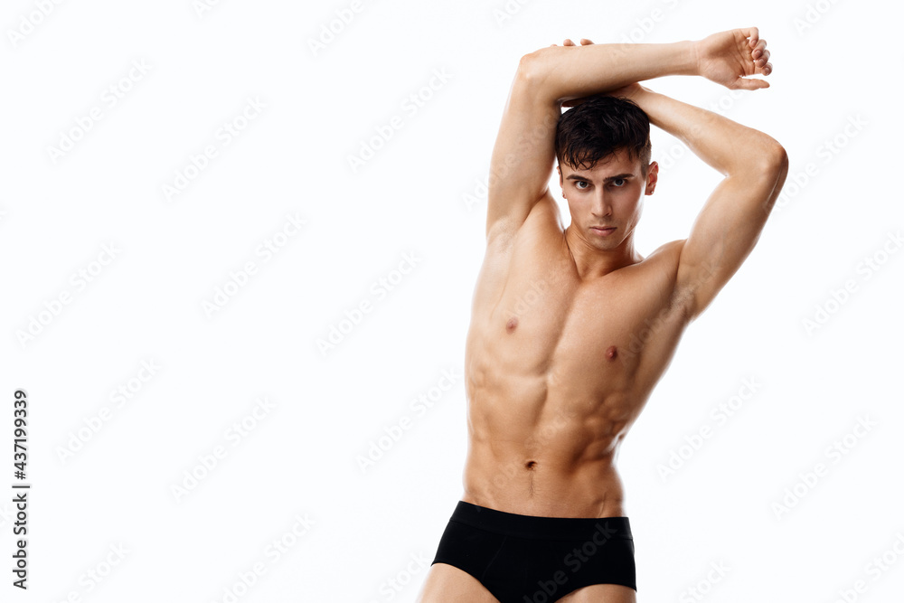 attractive sportsman with a pumped-up torso holds his arms above his head cropped view attractive sportsman with a pumped-up torso holds his arms above his head cropped view