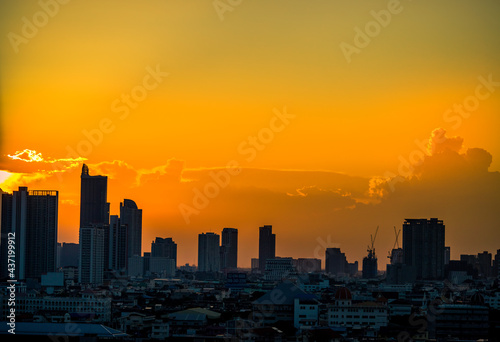 The blurred abstract background of the morning sun exposure to the tiny dust particles that surround the tall buildings in the capital, the long-term health issue of pollution.