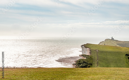 The South Downs coastline on the south coast of England with the Belle Tout lighthouse watching over the white chalk cliffs of the English Channel. photo