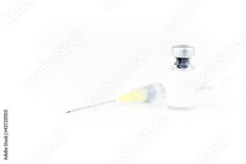 medicine bottle empty space label for text and syringe needle injected on white background. medical and treatment concept