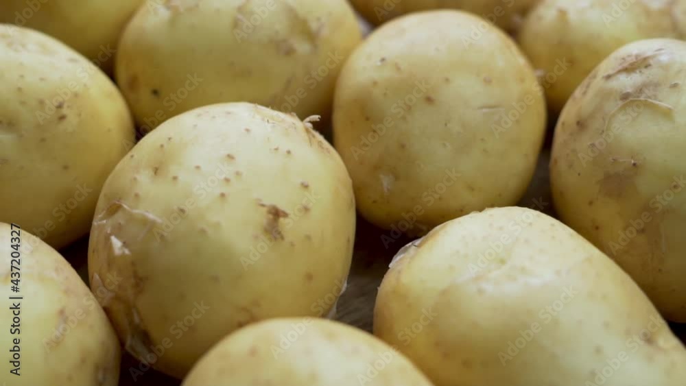 Unpeeled New Potatoes, Close-up. New Potatoes, Fruits, Vegetables, Tubers, Isolated. Background of Potatoes. Potatoes on The Counter, Market, Store. Vegan Food and Diet. Unpeeled New Potatoes, Close-up. New Potatoes, Fruits, Vegetables, Tubers, Isolated. Background of Potatoes. Potatoes on The Counter, Market, Store. Vegan Food and Diet.