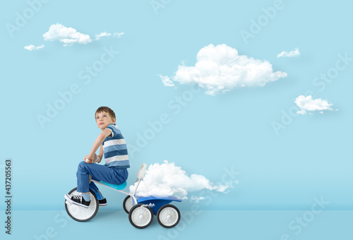 Concept of freedom mind success hope ambition and dream. Clouds creator, surreal concept. Boy carries cloud in the trunk of a bicycle.