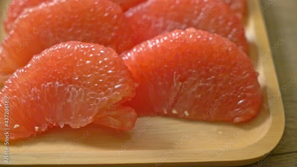 fresh red pomelo fruit or grapefruit on plate fresh red pomelo fruit or grapefruit on plate