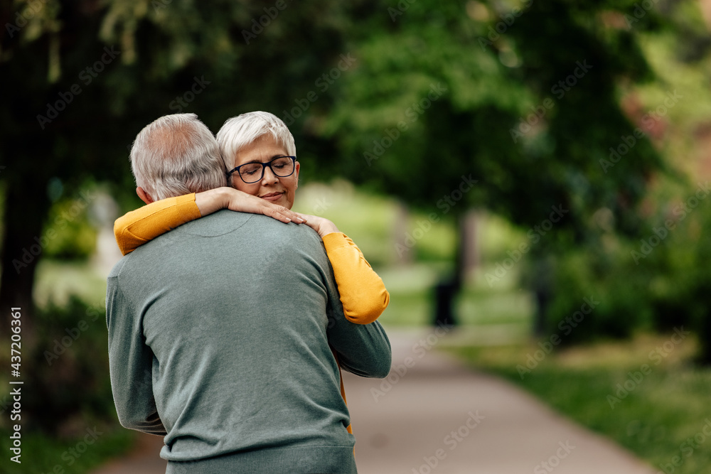Fototapeta premium Senior husband, gently holding his wife in his arms.