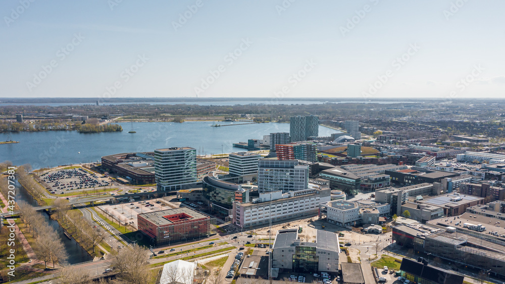 Almere city center, aerial view towards city hall, hospital and Weerwater lake. Flevoland, The Netherlands.