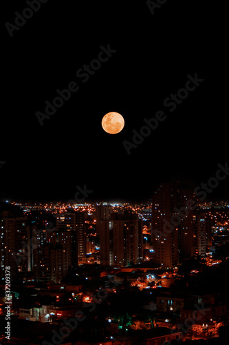 Super Moon 2021 at skyline and city lights in Brazil. Space for text.