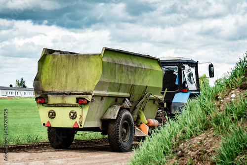 Tractor with manure in trailer on the road.