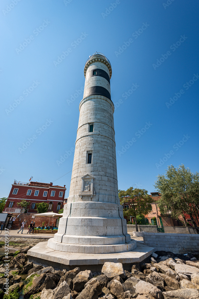 The ancient lighthouse of the island of Murano made of white stones. Punta Faro, Venice lagoon, UNESCO world heritage site, Veneto, Italy, Europe.