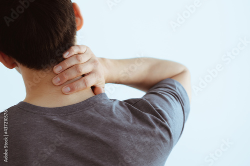 People, healthcare and problem concept - close up of man suffering from neck pain over gray background