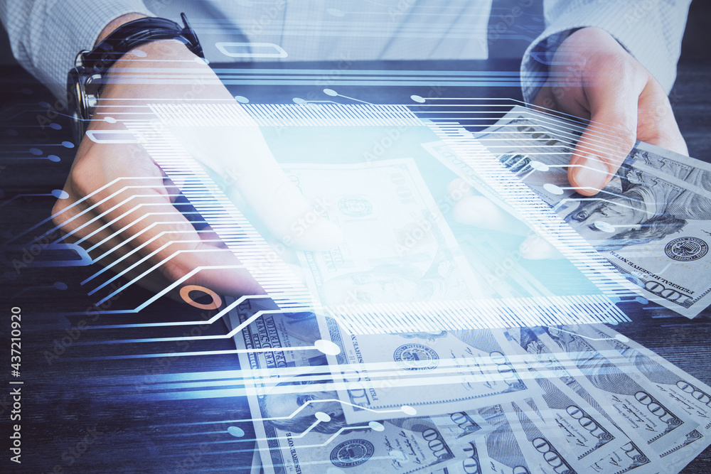 Double exposure of technology drawing hologram and us dollars bills and man hands. Data concept Double exposure of technology drawing hologram and us dollars bills and man hands. Data concept