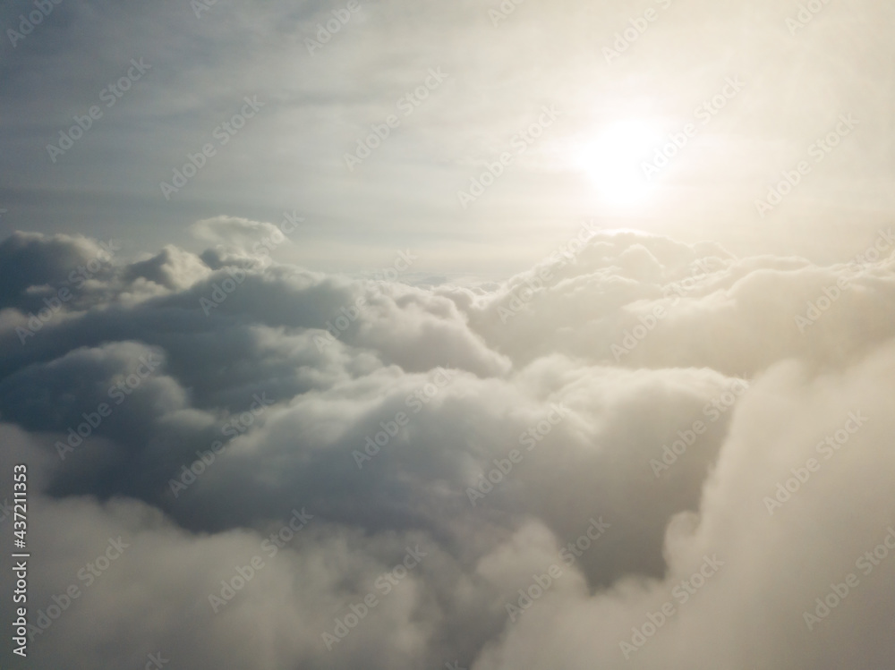 Aerial high flight above the clouds at sunrise. Aerial high flight above the clouds at sunrise.