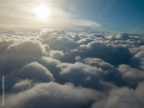 Fototapeta Naklejka Na Ścianę i Meble -  Aerial high flight above the clouds at sunrise.