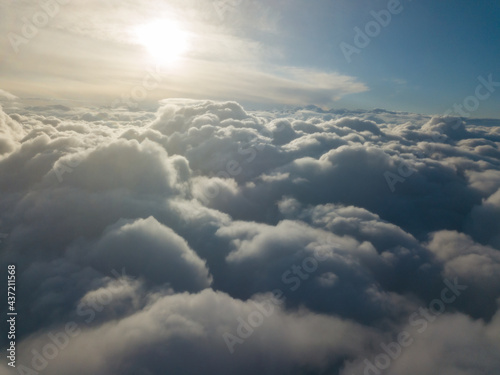 Aerial high flight above the clouds at sunrise. © Sergey