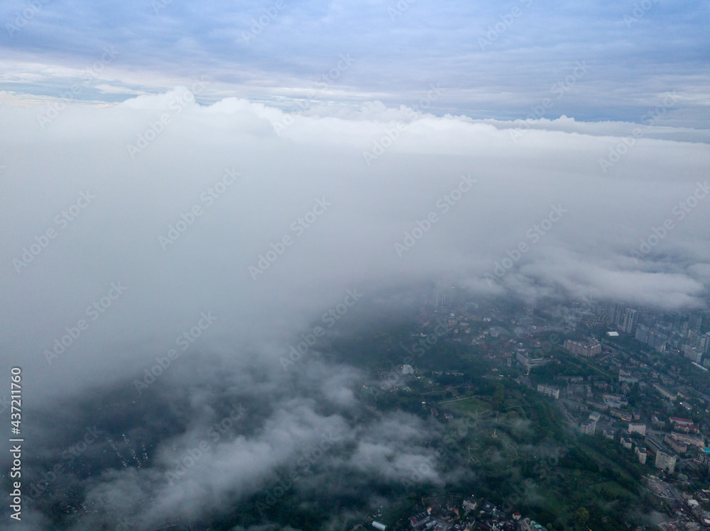 View of Kiev above the clouds at dawn. Aerial drone view.