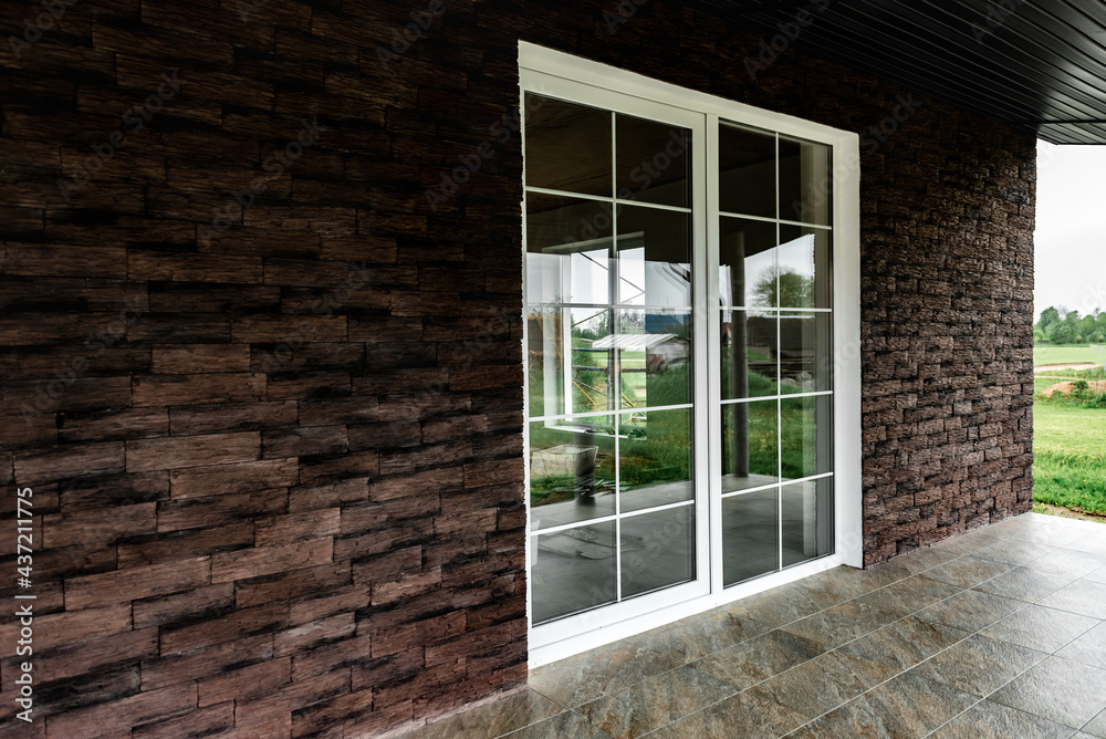 Fototapeta premium Facing the facade made of dark decorative torn bricks.