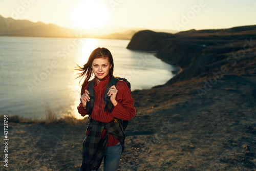 cheerful woman tourist with backpack travel freedom walk landscape
