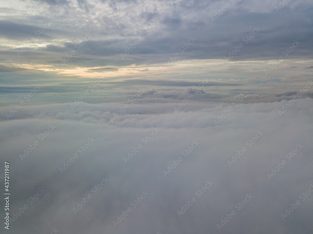 Aerial high flight above the clouds. The rays of the rising sun break through the clouds. Aerial high flight above the clouds. The rays of the rising sun break through the clouds.