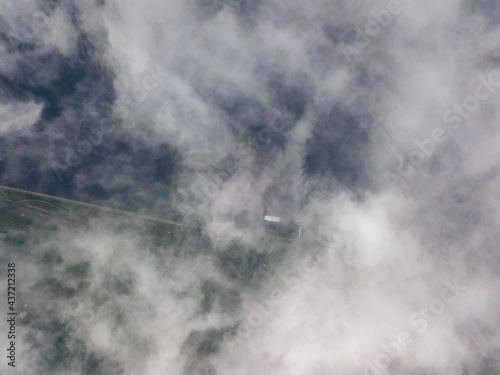 High view of the Dnieper River in Kiev. Aerial high flight above the clouds.