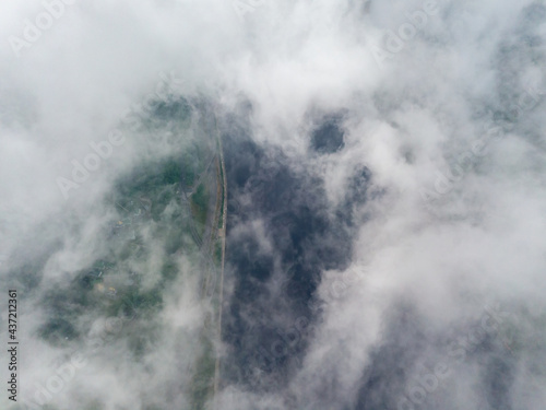 High view of the Dnieper River in Kiev. Aerial high flight above the clouds.