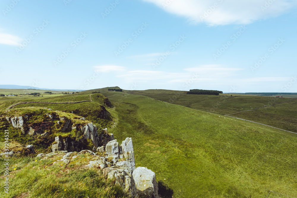 Northumberland UK: Hadrians Wall built on tall cliffs (Roman Wall) on a sunny summer day in English countryside
