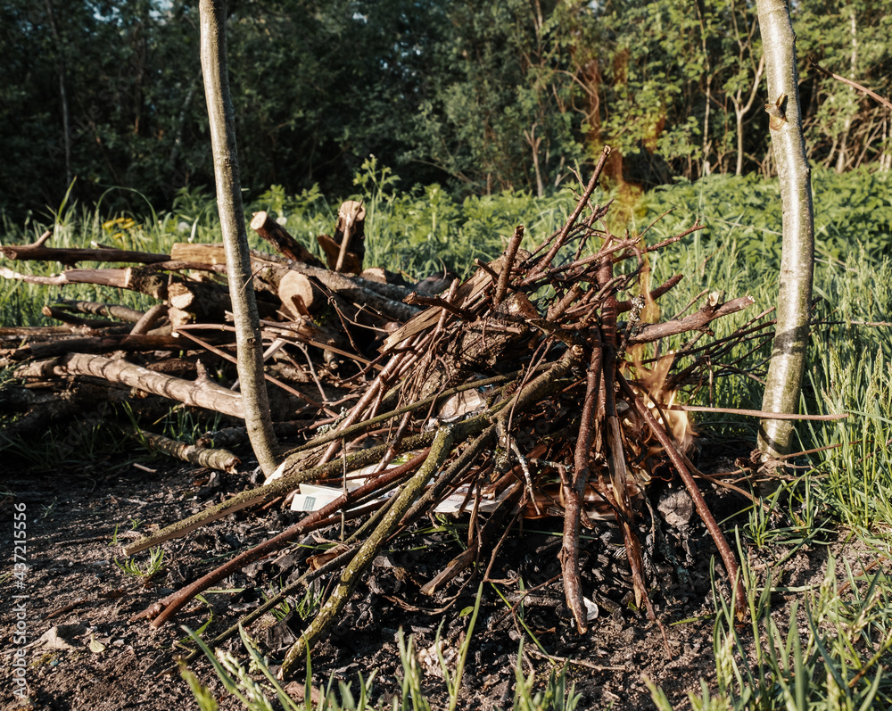 A fire breaks out from a heap of brushwood in a campfire site in a nature camp. A fire breaks out from a heap of brushwood in a campfire site in a nature camp.
