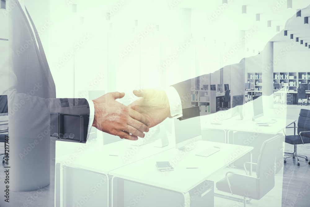 Handshake of two businessmen on furnished office interior background, deal and real estate concept. Multiexposure Handshake of two businessmen on furnished office interior background, deal and real estate concept. Multiexposure