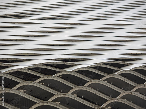 Corrugated metallic facade cladding photographed from below
