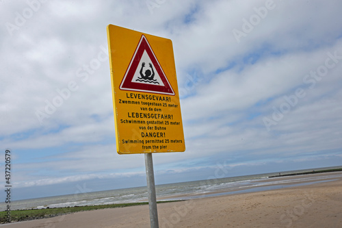 Warning sign at beach at Northsea coast Julianadorp Netherlands. Dangerous swimming grounds. Drowning danger.