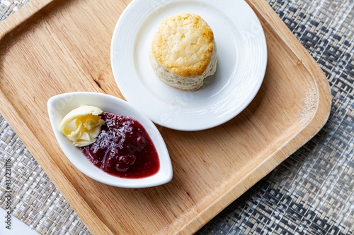 Wallpaper Mural Scones and strawberry jam cups on wooden trays on tables at the café Torontodigital.ca