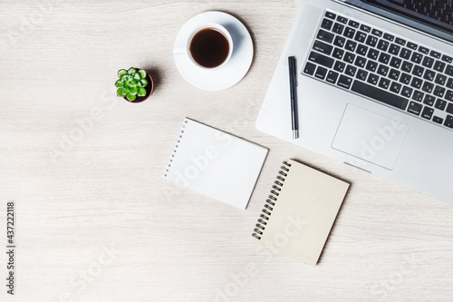 Office table with notepad  computer and coffee cup. Mockup  top view with copy space. Office desk table concept.