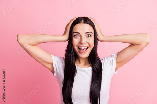 Portrait of attractive cheerful lucky girl great news reaction wow sale isolated over pink pastel color background