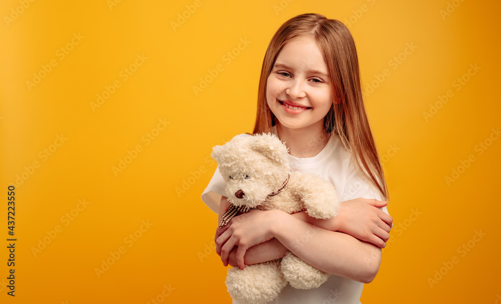 Little girl holding a teddy bear deals