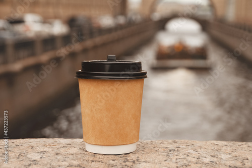 cup of natural coffee on bridge near embankment of Zimnyaya Kanavka Canal in St. Petersburg, copy space photo
