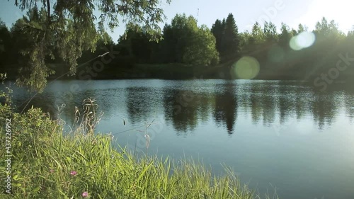 Quiet evening on the shore of a pond or lakeside where the sunset