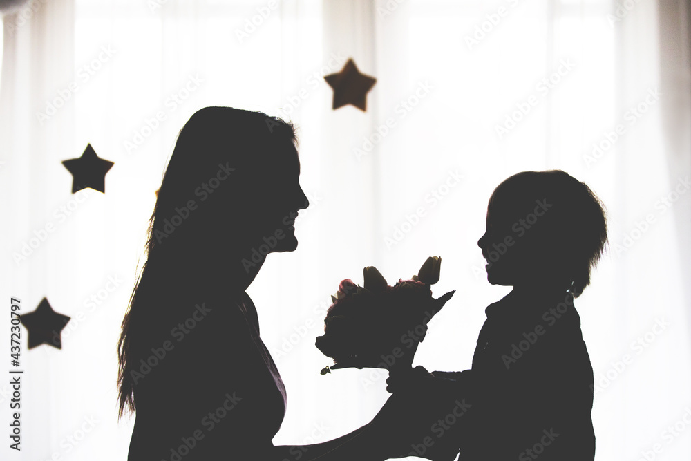 Silhouette of happy mother holding baby boy on hands, isolated
