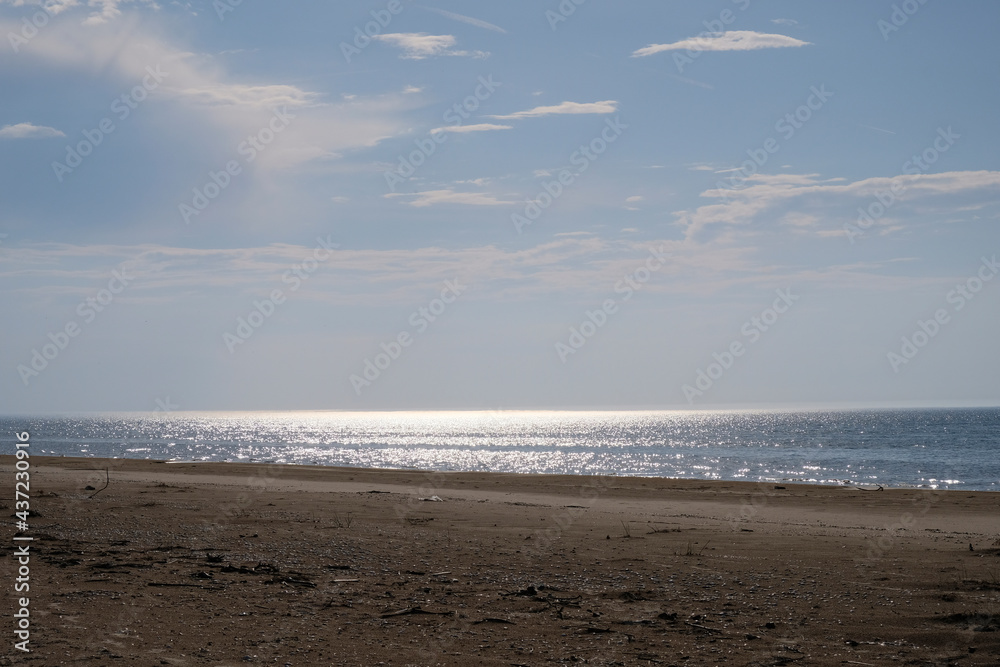 The wide, sandy beach of the Baltic Sea is dazzled by the morning sun The wide, sandy beach of the Baltic Sea is dazzled by the morning sun