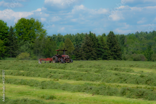Tractor making hay on the farm in Quebec, Canada